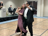 a man and woman dancing on a dance floor