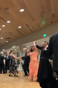a group of people dancing in a ballroom